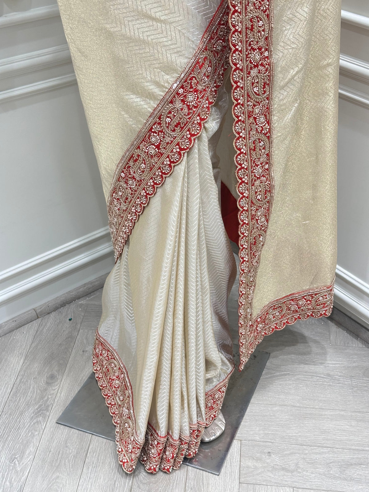 Ivory saree by Mamta Saree - close-up of red beaded pallu border